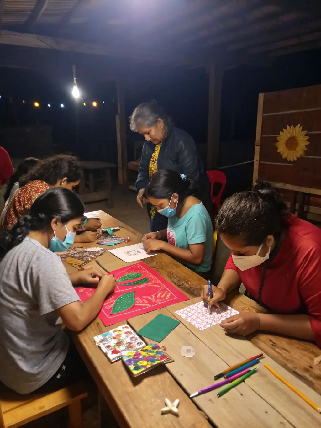 A photograph capturing a community workshop focused on traditional crafts and heritage skills, with participants actively engaged in learning.